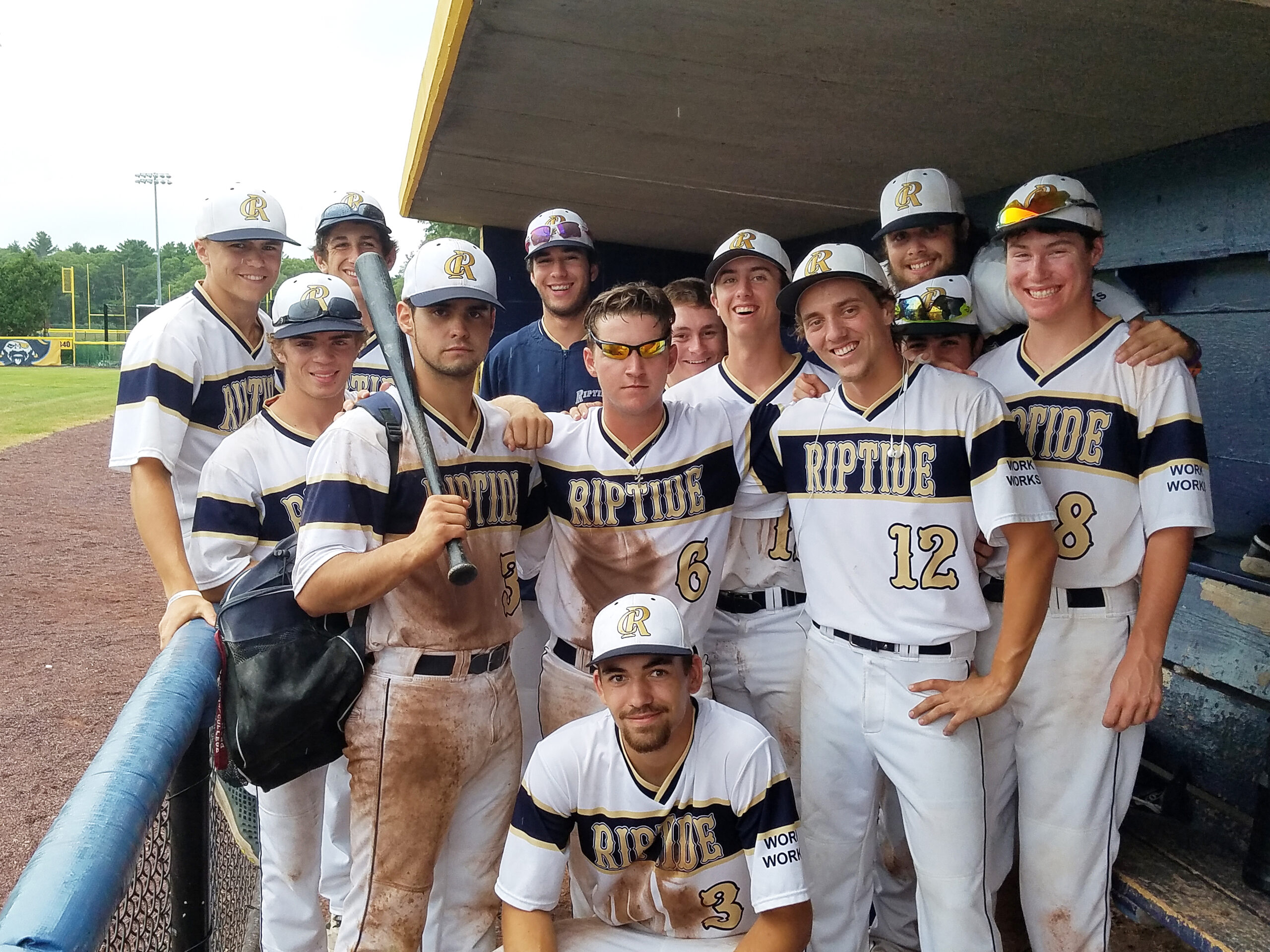 Cape Cod Riptide Baseball Club in the dugout at a wood bat tournament